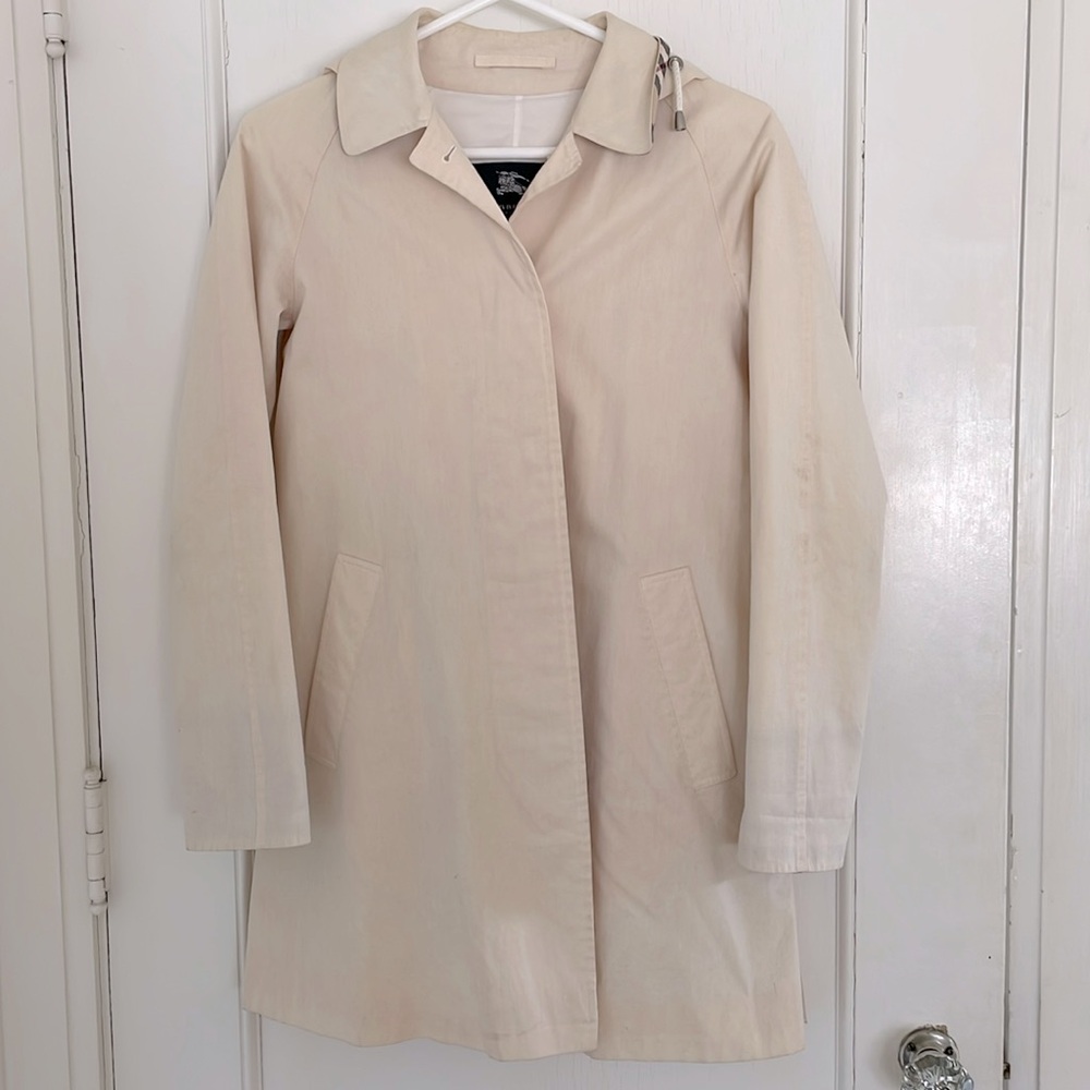 Soft pink Burberry trench coat with plaid checked hood and collar